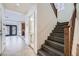 Entryway showcasing stairs, and access to the kitchen, living room and powder room at 10428 Mulvaney Cir, Las Vegas, NV 89141