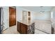 Open concept kitchen island with stone details and stainless steel appliances flowing into the living area at 10428 Mulvaney Cir, Las Vegas, NV 89141