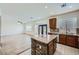 Open kitchen with an island featuring stone accents and stainless steel appliances overlooks the living area at 10428 Mulvaney Cir, Las Vegas, NV 89141
