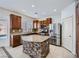 Stylish kitchen featuring an island with stone base, stainless steel appliances, and wooden cabinets at 10428 Mulvaney Cir, Las Vegas, NV 89141