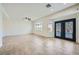 Spacious living room features recessed lighting, tile floors, and backyard access at 10428 Mulvaney Cir, Las Vegas, NV 89141