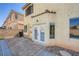 View of the backyard patio with pavers, a grill, and direct access into the home through french doors at 10428 Mulvaney Cir, Las Vegas, NV 89141