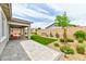 Covered patio and well-maintained artificial turf create an inviting outdoor living space in the backyard at 10972 Dixie Johnson Ave, Las Vegas, NV 89166