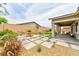 Landscaped backyard features artificial turf, pavers, gravel, and a covered patio, providing outdoor living at 10972 Dixie Johnson Ave, Las Vegas, NV 89166