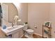 Charming powder room featuring a pedestal sink, floral arrangements, and modern fixtures at 10972 Dixie Johnson Ave, Las Vegas, NV 89166