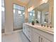 Bright bathroom features double sinks, modern fixtures, and a spacious glass-enclosed shower with marble tile at 10972 Dixie Johnson Ave, Las Vegas, NV 89166