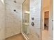 Modern glass enclosed shower with tiled walls and floor and stylish fixtures at 10972 Dixie Johnson Ave, Las Vegas, NV 89166