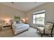 Cozy bedroom with a queen bed, neutral walls, carpet flooring, and a large window for natural light at 10972 Dixie Johnson Ave, Las Vegas, NV 89166