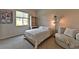 Bright bedroom featuring natural light, a cozy chair, and a Stephen Curry basketball poster at 10972 Dixie Johnson Ave, Las Vegas, NV 89166
