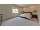 Bedroom with neutral carpet, a large window, and a classic wooden bed frame at 10972 Dixie Johnson Ave, Las Vegas, NV 89166