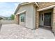 Stylish single story home showcasing the entrance, stone accents, an outdoor area, and paved driveway at 10972 Dixie Johnson Ave, Las Vegas, NV 89166
