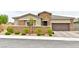 Charming single story home with stone accents, neat landscaping, and an attached two car garage at 10972 Dixie Johnson Ave, Las Vegas, NV 89166