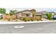 Charming single story home with stone accents, neat landscaping, and an attached two car garage at 10972 Dixie Johnson Ave, Las Vegas, NV 89166