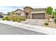 Charming single story home with stone accents, neat landscaping, and an attached two car garage at 10972 Dixie Johnson Ave, Las Vegas, NV 89166