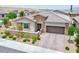 Beautiful single-story home showcasing desert landscaping, stone accents, and a welcoming entrance at 10972 Dixie Johnson Ave, Las Vegas, NV 89166