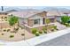 Charming single-story home featuring a desert landscape, well-maintained lawn, and stone accents at 10972 Dixie Johnson Ave, Las Vegas, NV 89166