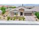 Attractive single-story home with a neutral color palette, stone accents, and a paved driveway at 10972 Dixie Johnson Ave, Las Vegas, NV 89166