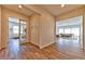 Hallway with wood-look tile flooring leading to an office and a spacious living area at 10972 Dixie Johnson Ave, Las Vegas, NV 89166
