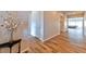 Bright hallway featuring beautiful wood-look tile flooring and neutral walls, leading to the living area at 10972 Dixie Johnson Ave, Las Vegas, NV 89166