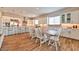 Spacious kitchen with white cabinetry, stainless appliances, and a dining table at 10972 Dixie Johnson Ave, Las Vegas, NV 89166