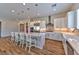 Stylish kitchen with modern lighting, stainless appliances and expansive island seating at 10972 Dixie Johnson Ave, Las Vegas, NV 89166
