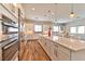 Open concept kitchen with an island, stainless appliances, and adjacent breakfast nook at 10972 Dixie Johnson Ave, Las Vegas, NV 89166