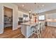Open kitchen with white cabinets, large island with seating, and stainless appliances at 10972 Dixie Johnson Ave, Las Vegas, NV 89166