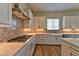 Bright kitchen featuring stainless steel appliances, white cabinetry, and chevron backsplash at 10972 Dixie Johnson Ave, Las Vegas, NV 89166