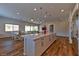 Open-concept kitchen and dining area with a large island and modern pendant lighting at 10972 Dixie Johnson Ave, Las Vegas, NV 89166