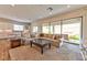 Bright living room with a comfortable sectional and access to the outdoor space at 10972 Dixie Johnson Ave, Las Vegas, NV 89166