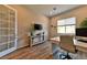 Home office featuring wood floors, a built-in desk, and a large window at 10972 Dixie Johnson Ave, Las Vegas, NV 89166