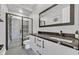 Sleek bathroom featuring dual shower heads behind glass door, marble countertop, and black fixtures at 112 Springbough Ln, Las Vegas, NV 89138