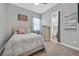 Cozy bedroom featuring neutral paint, comfortable bedding, a dresser, and an ensuite bathroom at 112 Springbough Ln, Las Vegas, NV 89138