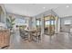 Elegant dining room with modern chandelier, seating for eight, and access to outdoor area at 112 Springbough Ln, Las Vegas, NV 89138