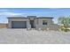 Charming single-story home featuring a paved driveway, two-car garage, and gated courtyard at 112 Springbough Ln, Las Vegas, NV 89138