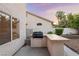 Outdoor kitchen area equipped with a built-in grill and bar space, ideal for entertaining at 1206 Evening Canyon Ave, Henderson, NV 89014
