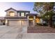 Two-story home with a tile roof, three-car garage, and manicured landscaping at 1206 Evening Canyon Ave, Henderson, NV 89014