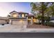 Two-story home with a tile roof, three-car garage, and mature trees in the front yard at 1206 Evening Canyon Ave, Henderson, NV 89014