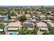 Aerial view of a residential neighborhood with a house featuring solar panels and a red tile roof at 1371 Cumulus Ct, Henderson, NV 89014
