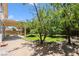 Secluded backyard featuring a spacious patio area, mature trees, and a well-maintained lawn for outdoor enjoyment at 1371 Cumulus Ct, Henderson, NV 89014