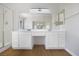 Bright bathroom features a double sink vanity with modern fixtures and a glass enclosed shower at 1371 Cumulus Ct, Henderson, NV 89014
