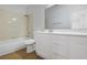 Bright bathroom featuring a tub and shower combination, white vanity with storage, and wood-look flooring at 1371 Cumulus Ct, Henderson, NV 89014