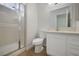 Bathroom featuring a shower with glass doors, sink, and toilet at 1371 Cumulus Ct, Henderson, NV 89014