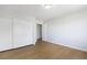 Bright bedroom with double closets, wood flooring and a view of the hallway at 1371 Cumulus Ct, Henderson, NV 89014