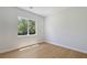 Bright bedroom featuring a large window with views and wood-look flooring at 1371 Cumulus Ct, Henderson, NV 89014