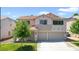Two-story home featuring a three-car garage, tile roof, and lush lawn, perfect for Gathering living at 1371 Cumulus Ct, Henderson, NV 89014
