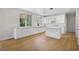 Bright kitchen with modern white cabinets, an island, stainless appliances, and light wood floors at 1371 Cumulus Ct, Henderson, NV 89014
