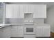 Well-equipped kitchen with white cabinetry, countertops and stainless steel appliances at 1371 Cumulus Ct, Henderson, NV 89014