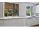 Bright kitchen with white countertops, cabinets and a backyard view from the window at 1371 Cumulus Ct, Henderson, NV 89014