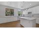 Modern kitchen with a large island, white cabinetry, and stainless steel appliances at 1371 Cumulus Ct, Henderson, NV 89014